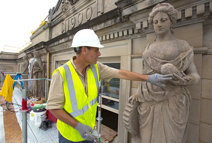 Conservator Francis Miller with a Marston sculpture.