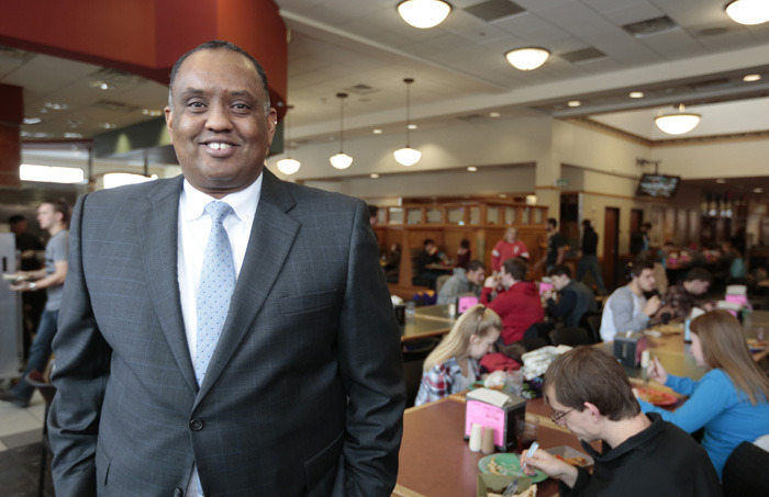 Mohamed Ali stands in the Marketplace dining center
