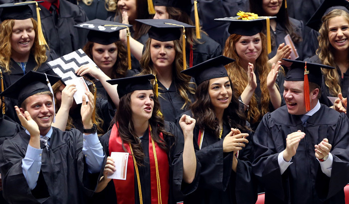 Graduating students applaud each other