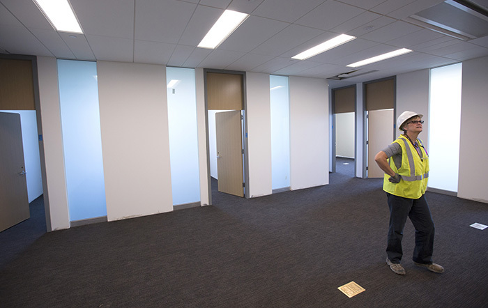 Project manager looks at empty office suite