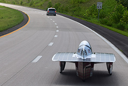 solar car trails a lead van on insterstate