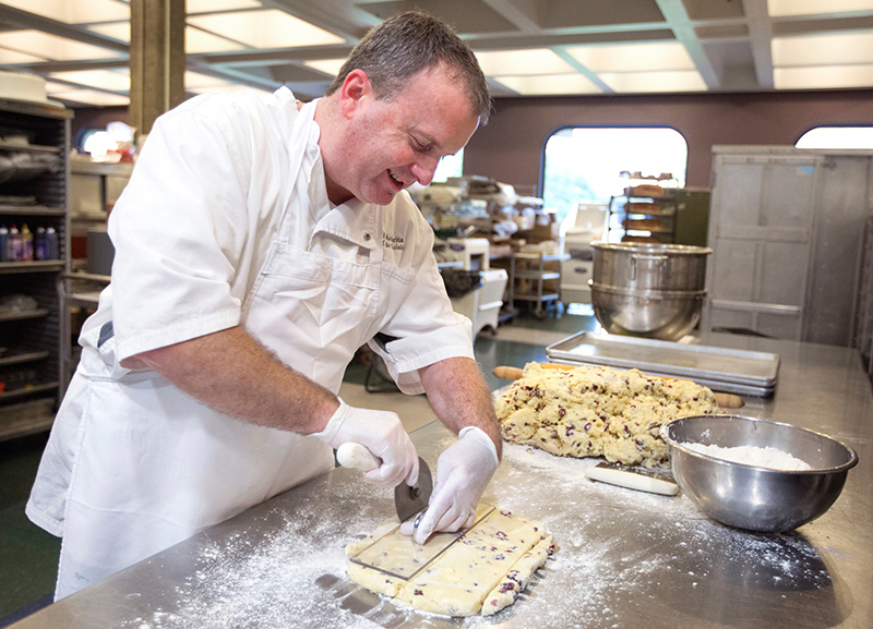 Pastry chef cuts scones by hand