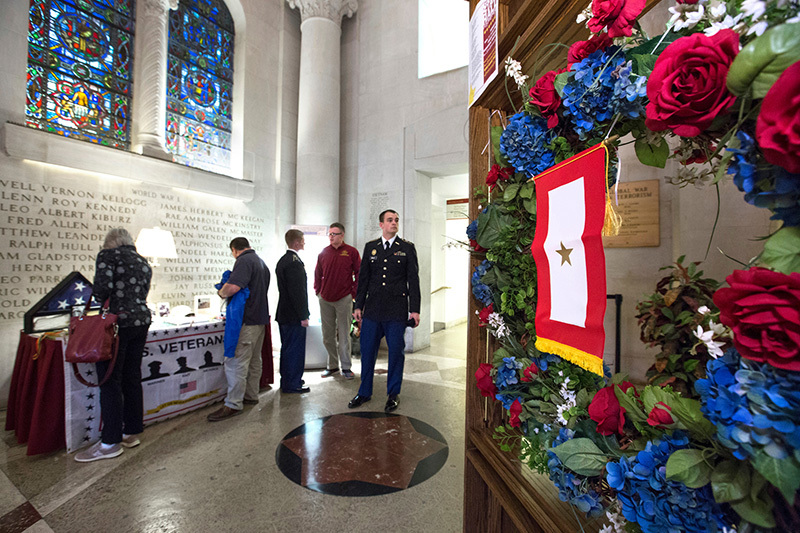 Visitors look over an exhibit in Gold Star Hall
