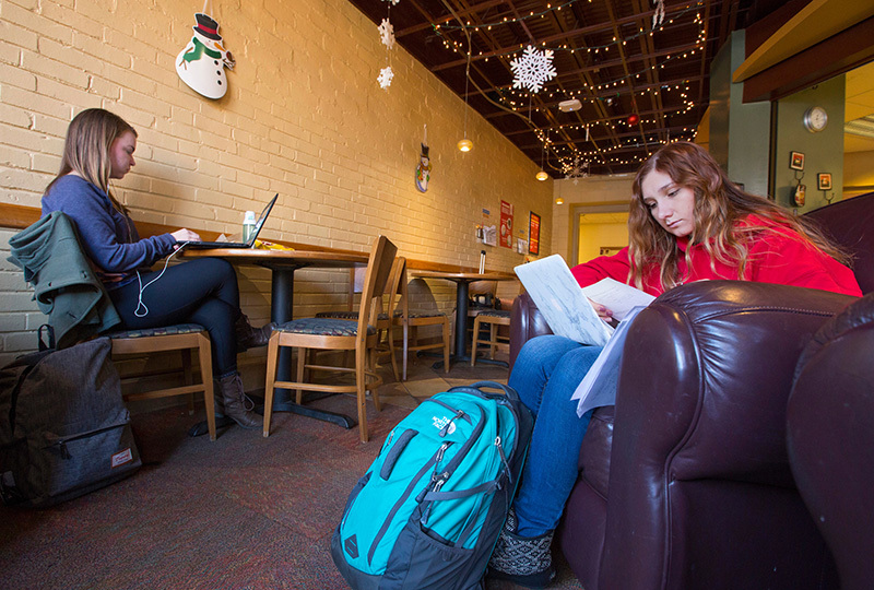 Two female students study in a campus cafe