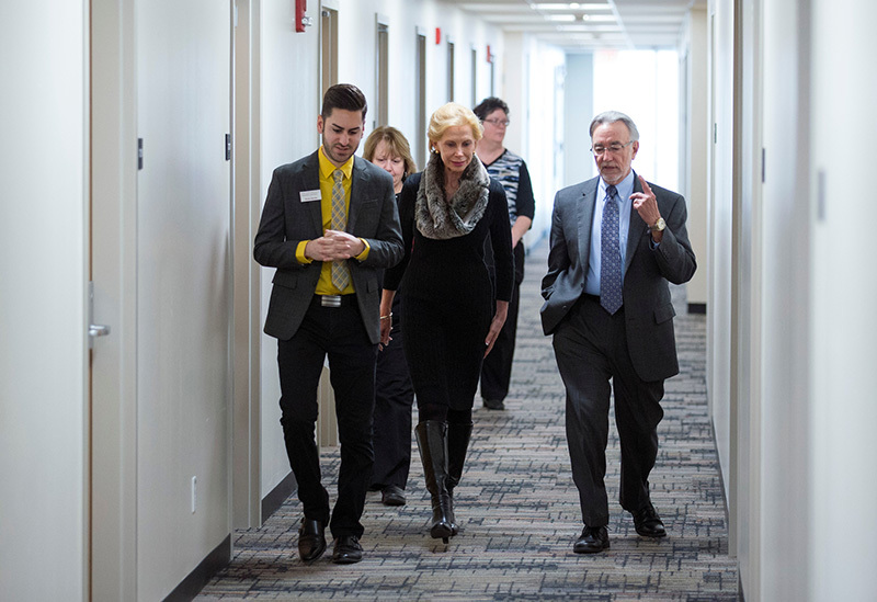 Group walks down residence hallway