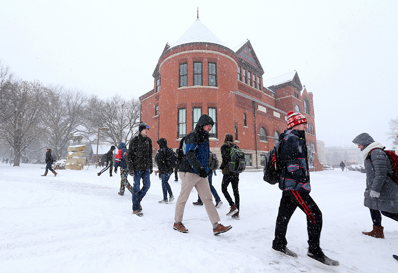 Walkers in the snow south of Morrill Hall