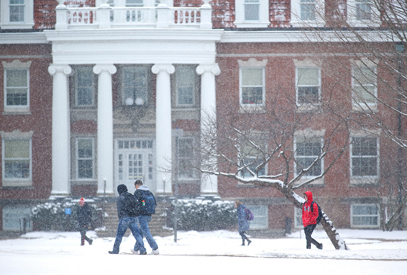 Snow falls on students near Enrollment Services Center.