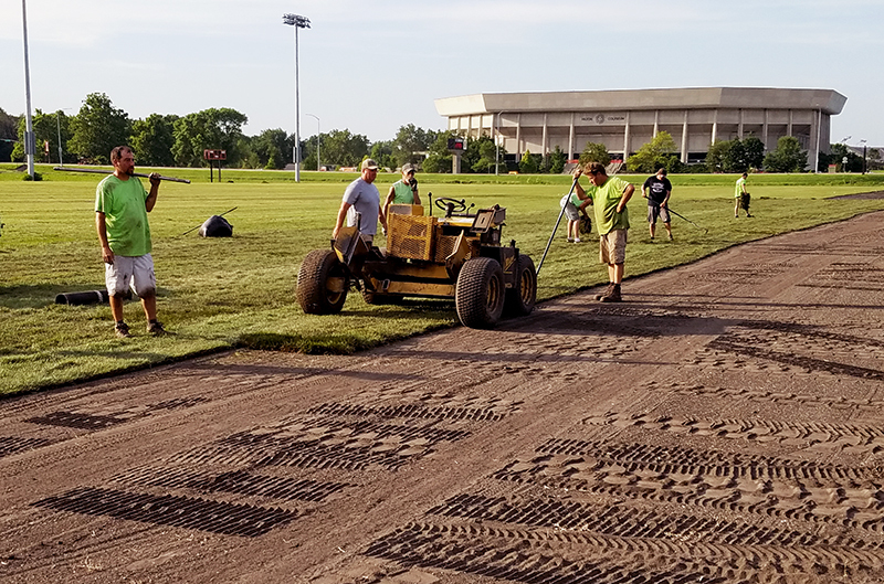 Crew lays sod on the east intramural field