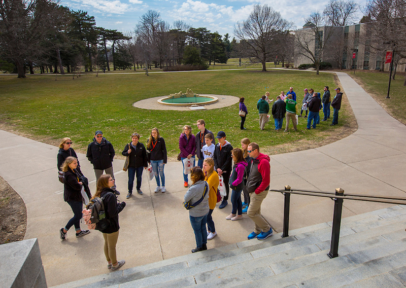 Two tour groups congregate south of MacKay Hall
