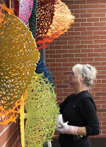 Susan Chrysler White and her "Coalesce" sculpture.