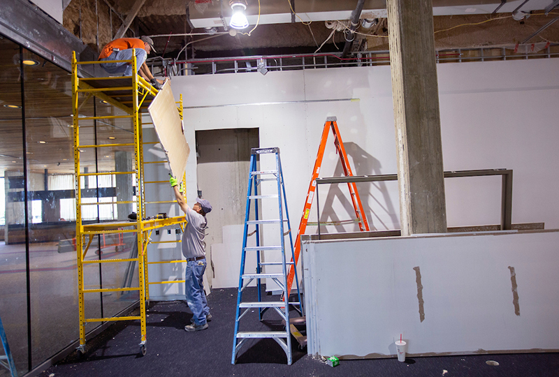 Drywall workers in the Brunnier museum space