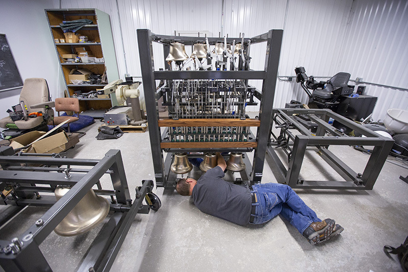Josh Meeks assembling the bells in the model carillon's center s