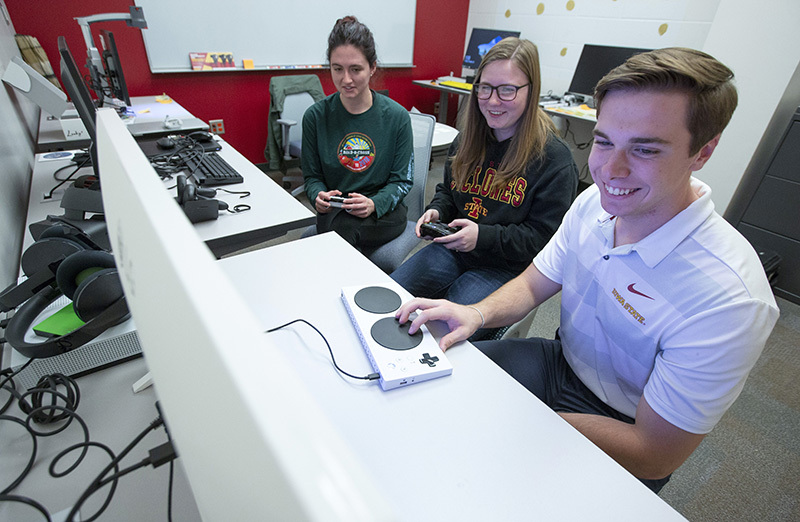Students work with an adaptive controller.