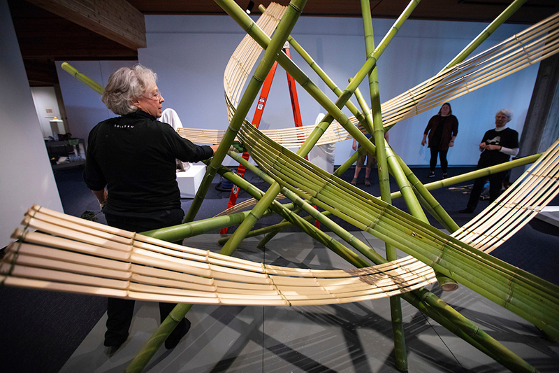 Marcia Borel adjusts a piece of bamboo