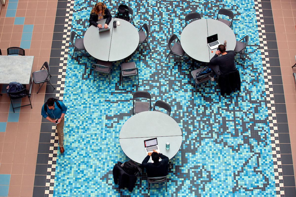 Students study on top of a mosaic floor in the Molecular Biology