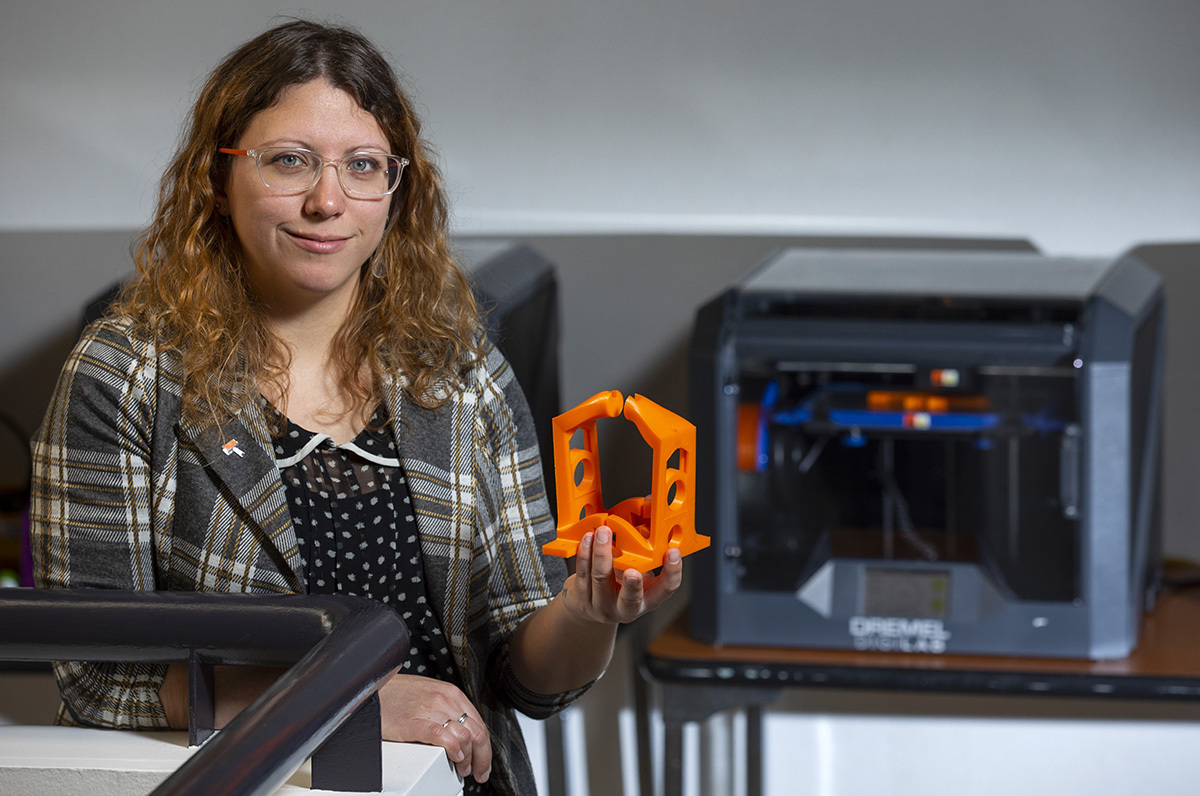 Raluca Iancu shows the 3D-printed mini press created for her pri