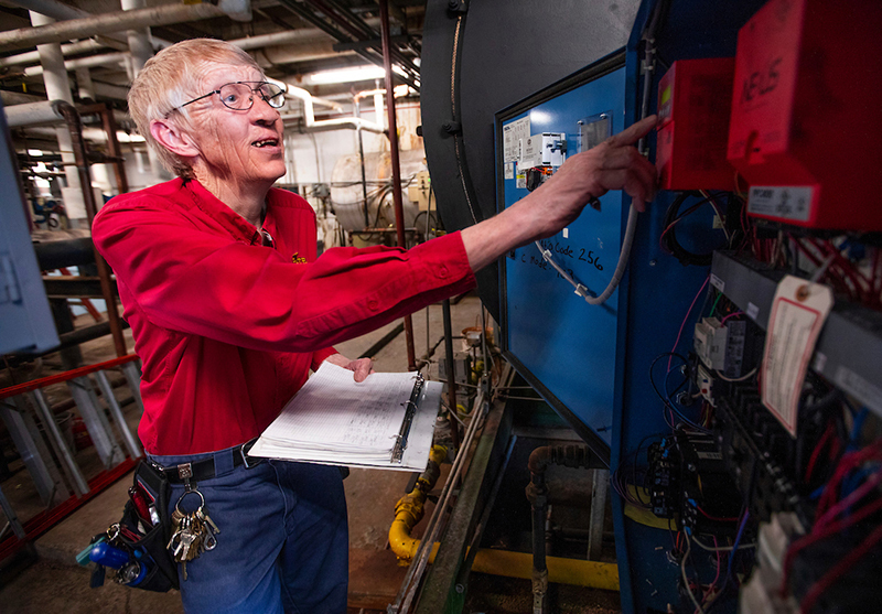 Mike Cleaveland checks a boiler control panel