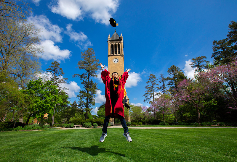 PhD candidate Thanh Nguyen jumps for joy on central campus