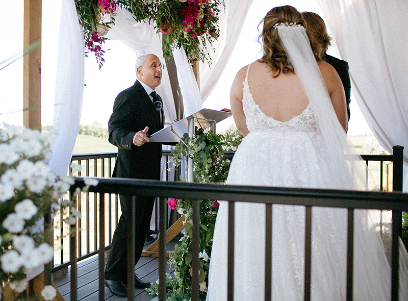 Faculty member officiates at outdoor wedding ceremony