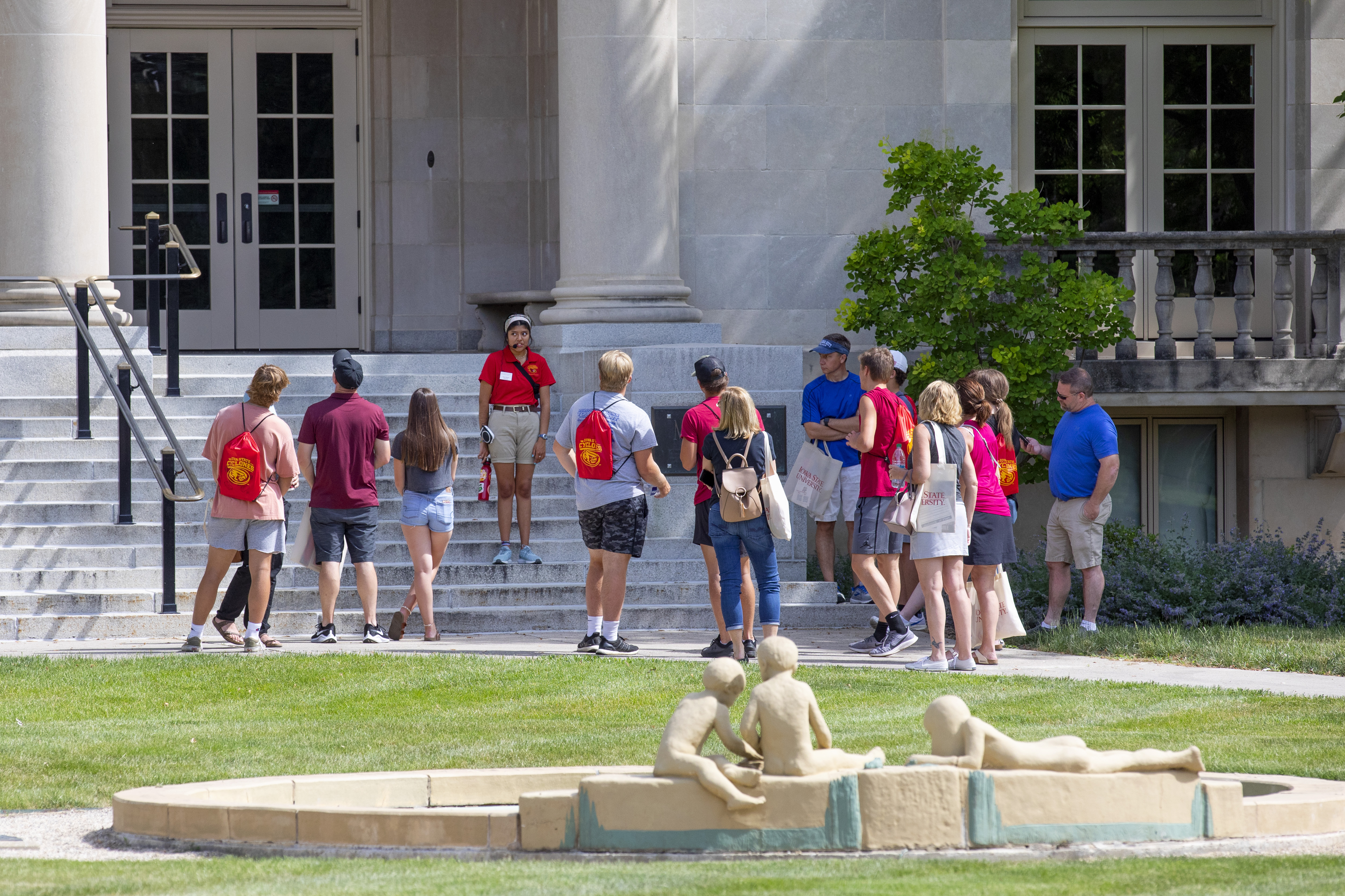 A group of orientation students on a campus tour stop outside Ma