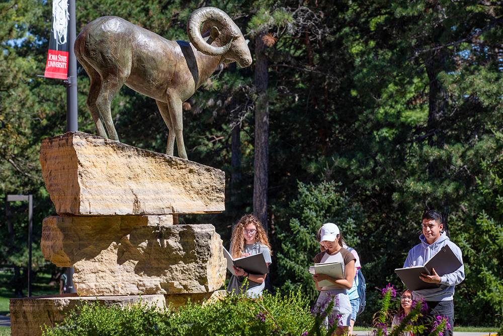 Students sketch a bighorn sheep sculpture