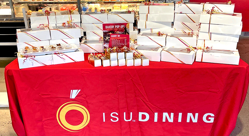 Table of boxed bakery products on red ISU Dining cloth