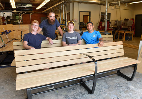 Industrial design students with bench project