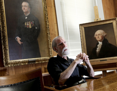 Bauman with two recently conserved paintings