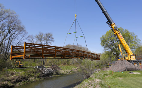 Crane lifts steel bridge across Squaw Creek