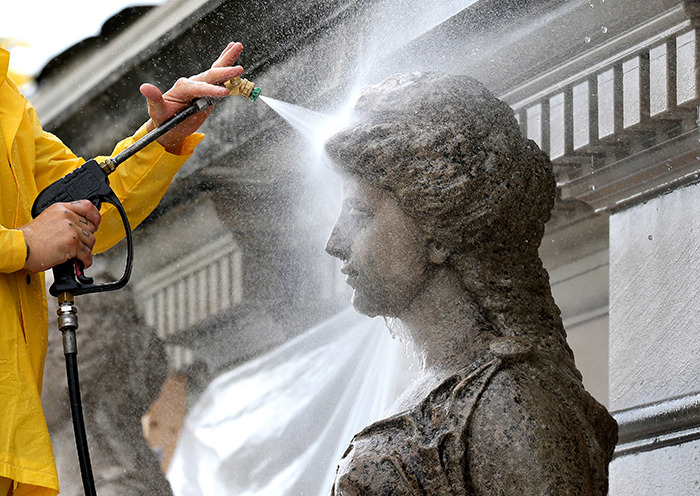 Power washing a Marston Muse sculpture.