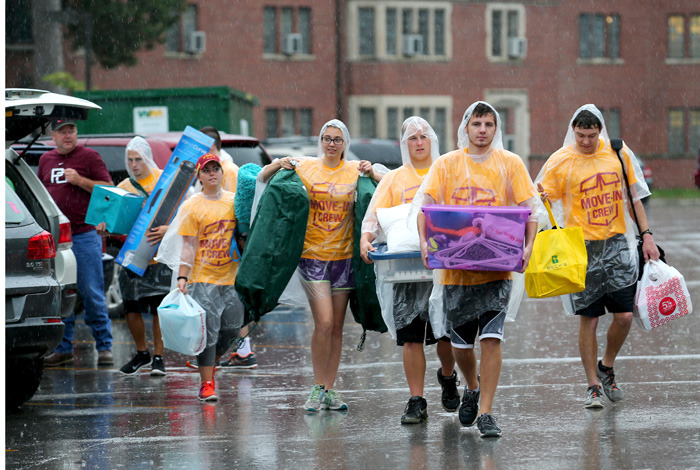 Seven students haul dorm gear in the rain