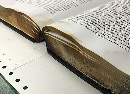 Water, smoke and fire damage to a book.