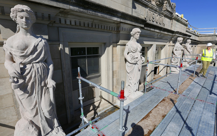 Four limestone female sculptures near the top of Marston Hall