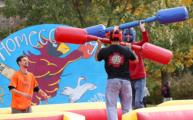Students compete on inflatable games set up during homecoming.