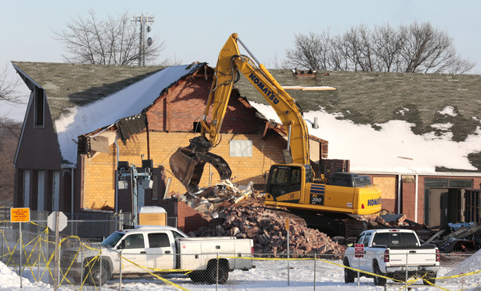 excavator sorts building rubble for recycling