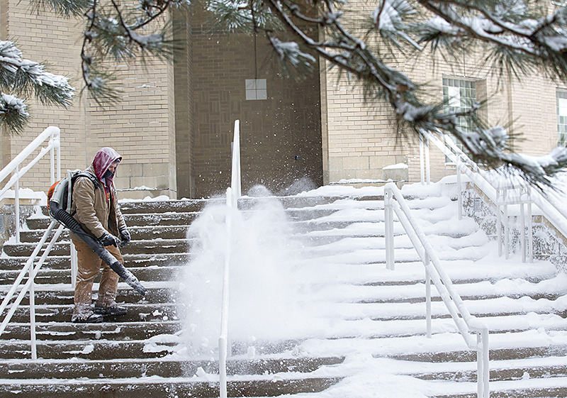 Ken Mueller blowing snow off the steps of the Food Sciences Buil