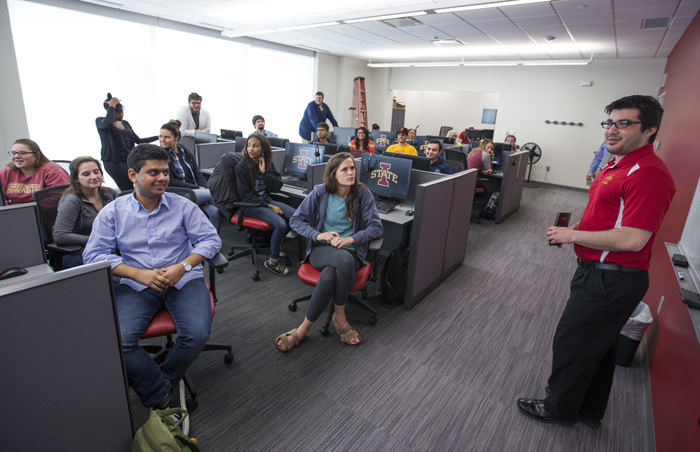 Student employees in call center receive instructions.