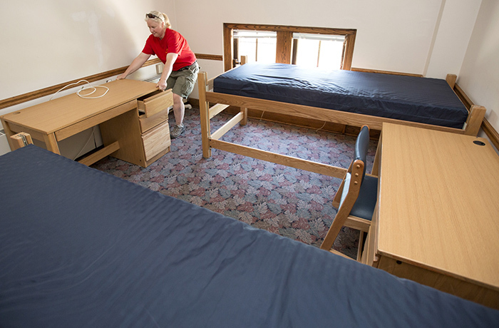 Woman moves desk into student residence