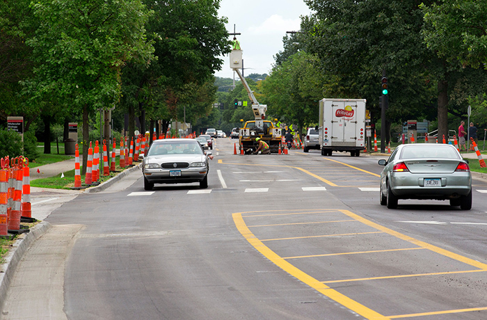 vehicles on new two-lane road with center painted medians and tu