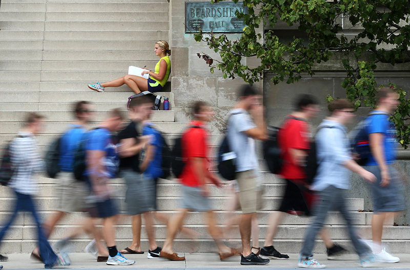 Students pass by the steps of Beardshear Hall