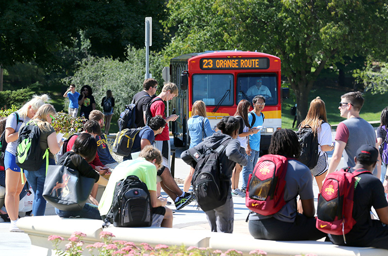Students at a CyRide bus stop