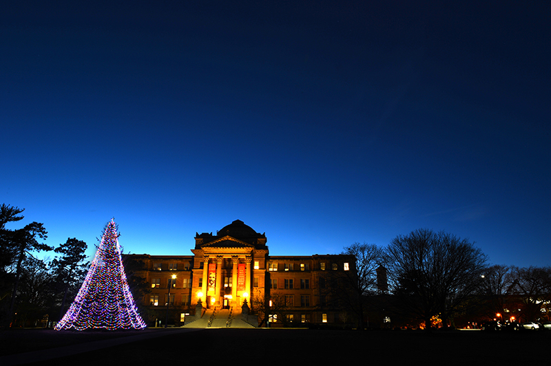 Holiday tree at dusk outside Beardshear Hall