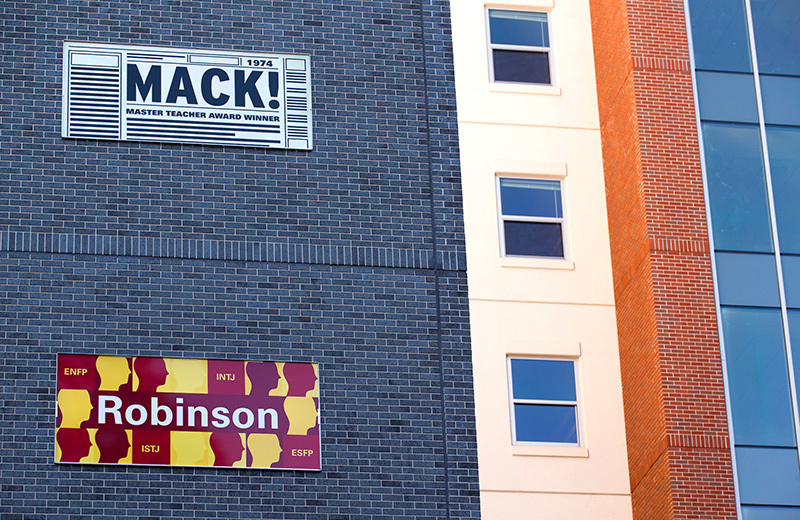 Two exterior signs on residence building read Mack and Robinson