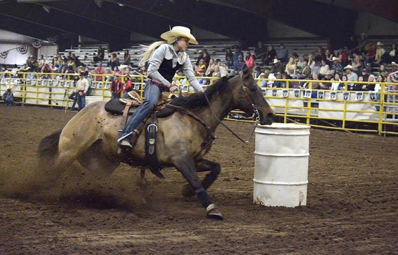 Barrel racing competitor in action