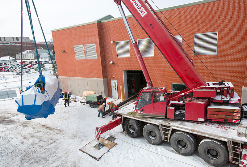 Steel beams are layed in place to support a wrapped chiller cyli