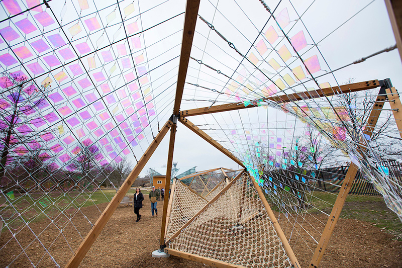 Wood, rope and iridescent panels structure