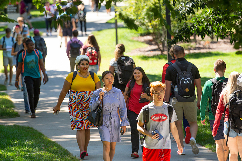 Students walk on central campus sidewalks