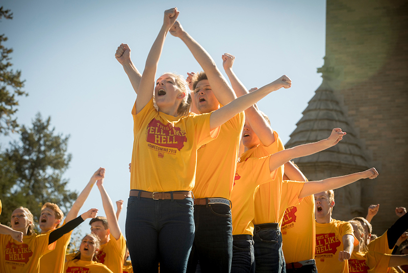 Students cheering in yellow 'yell like hell' T-shirts