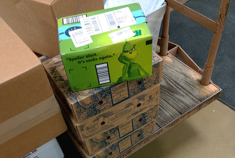 Holiday boxes stacked up on a cart in the ISU mailroom