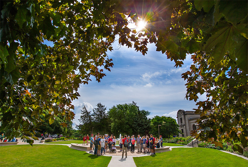 Tour group gathers at the fountain outside the Memorial Union